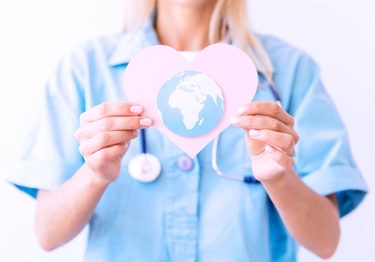 front view female doctor with stethoscope holding paper heart